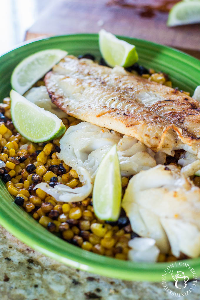 When the fish is done, set it on a plate right next to the grill, and set up a foil tent that funnels heat from the hot side of the grill down onto the fish to keep it warm.