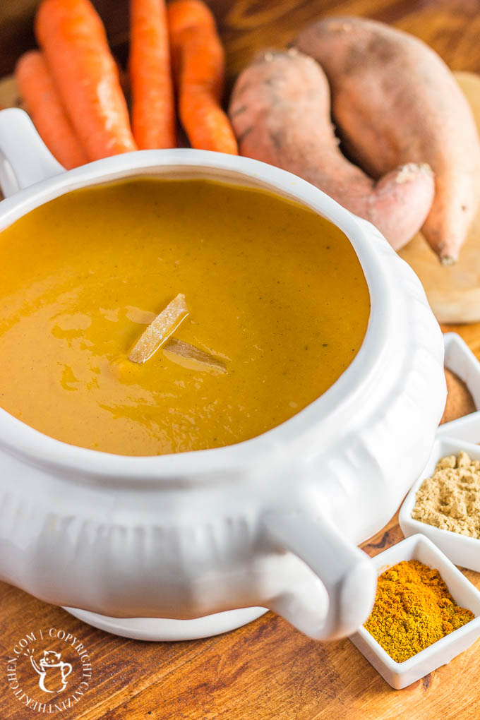 This easy recipe for slow cooker curried sweet potato & carrot soup is spice-forward! Bland soup be gone, this creamy bowl of spiced goodness will delight your tastebuds!