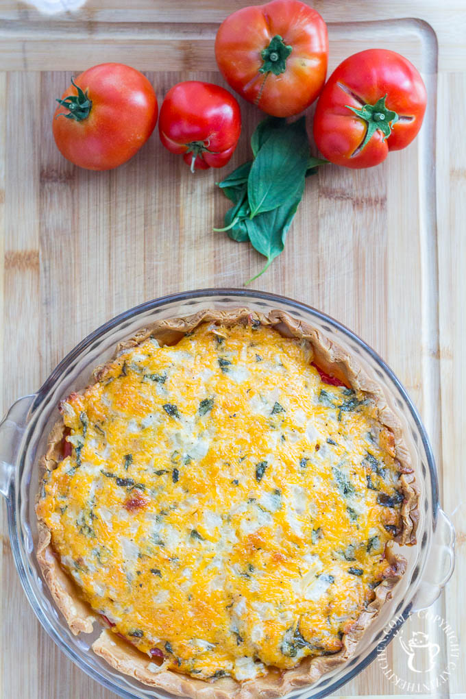 Fresh, a little rustic, and oh-so-tasty, this Tomato Basil Pie recipe is just the dish to showcase those tomatoes bursting out of your garden this fall!
