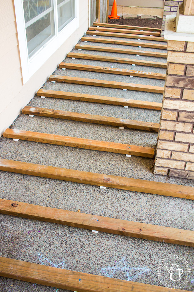 If you've ever thought about turning your cement porch into a wood deck, it's surprisingly easy! Here are some thoughts, tips, & photos from our experience!