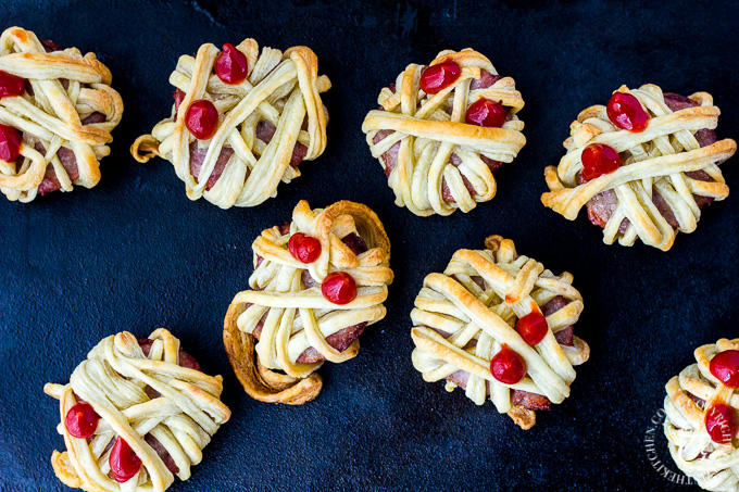 These silly little undead Halloween treats will delight the young people in your home...and the adults, too! Who doesn't want to munch on sausage mummies? #Halloween