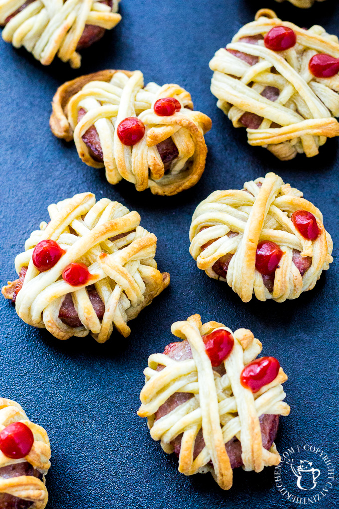 These silly little undead Halloween treats will delight the young people in your home...and the adults, too! Who doesn't want to munch on sausage mummies? #Halloween