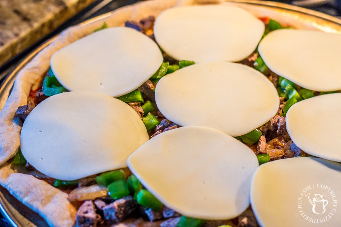 Love the classic combo of steak, cheese, and fried onions? Turn that sandwich craving into pie form with this easy and quick Philly Cheesesteak Pizza! 