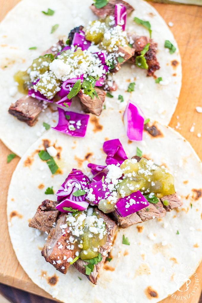 These steak street tacos are super tasty and incredibly easy to make! An inexpensive cut of steak works great, grilled alongside corn tortillas, with a fresh cabbage and salsa topping!